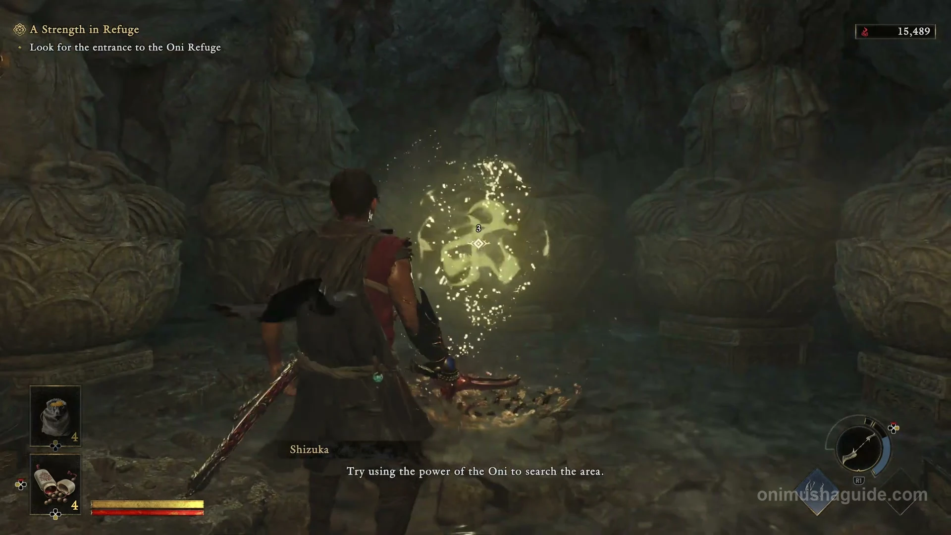 Golden Oni Glyph in front of the seated cave statues between two metal lamps