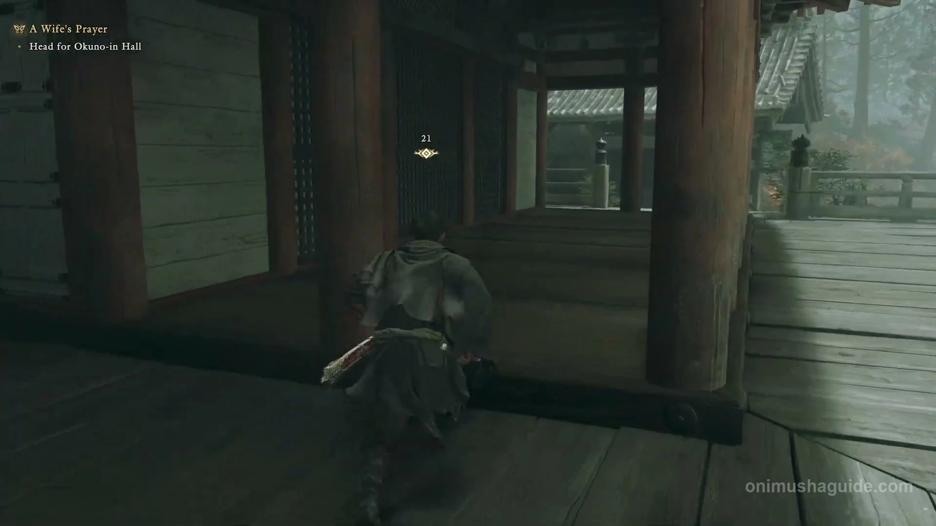 Wooden veranda leading around the hall toward the praying wife