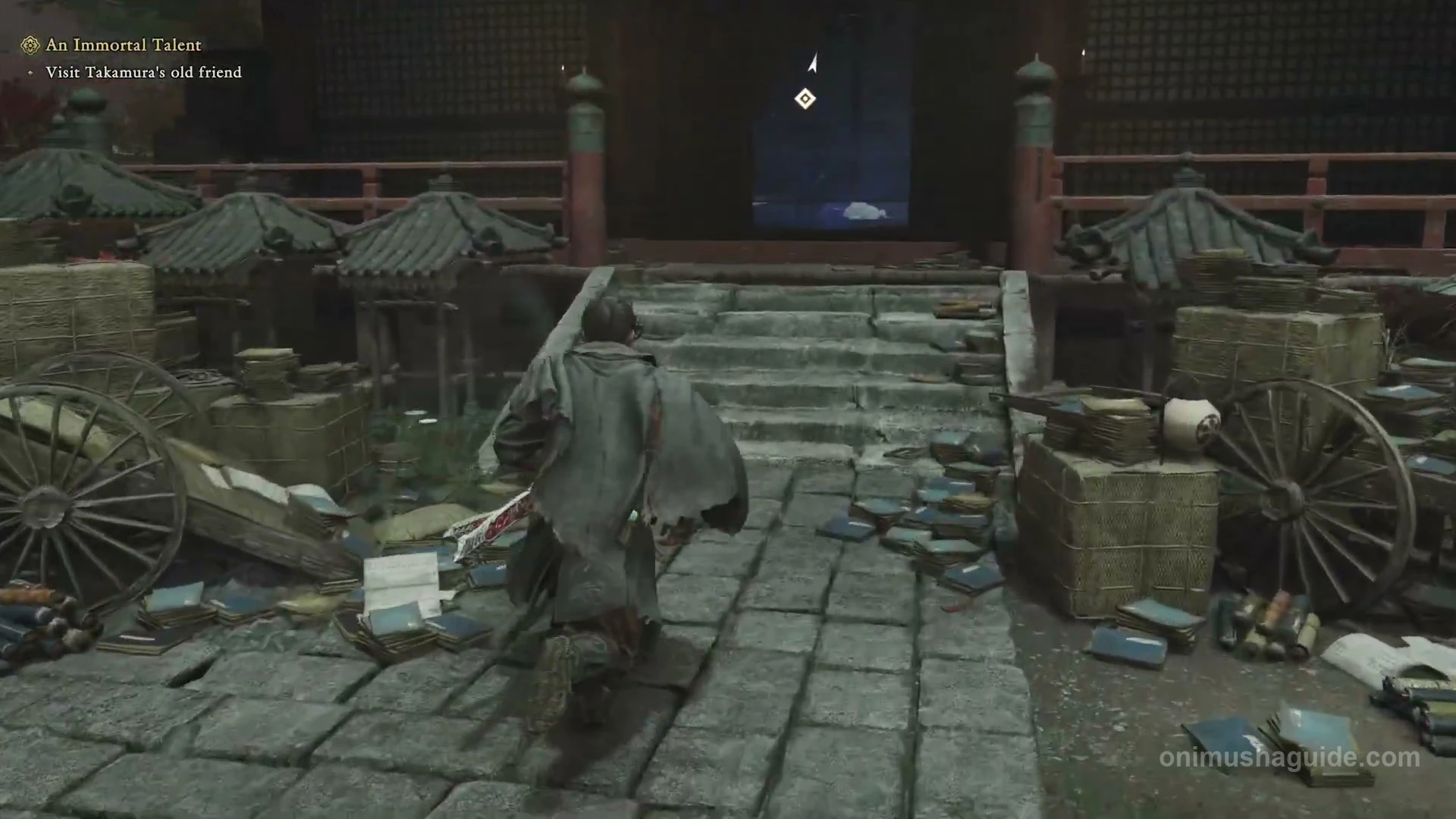 Stone steps to Lady Murasaki's open doorway, surrounded by scattered books, carts and crates