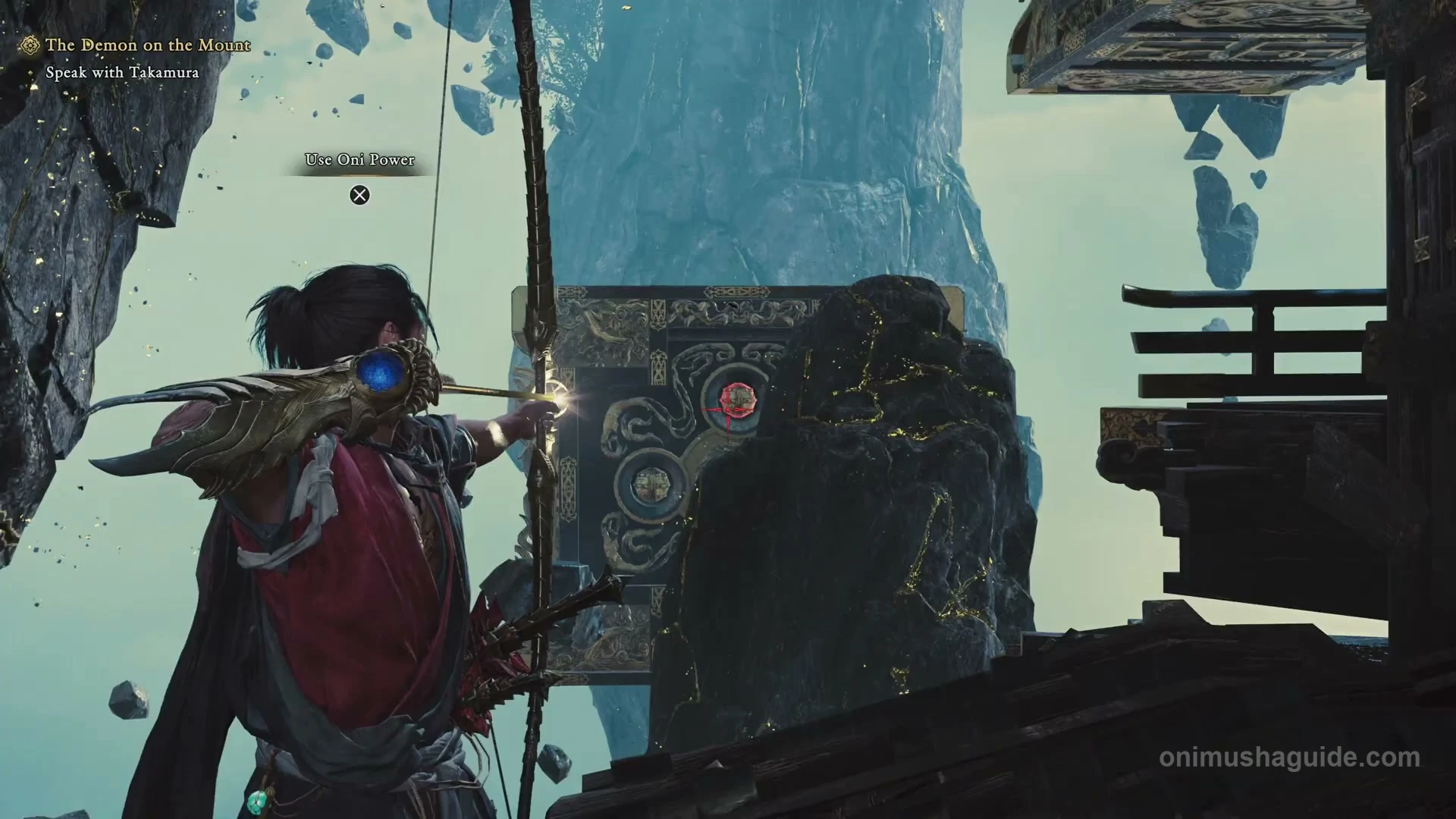 First red bow target on the ornate block across the gap from the tower roof
