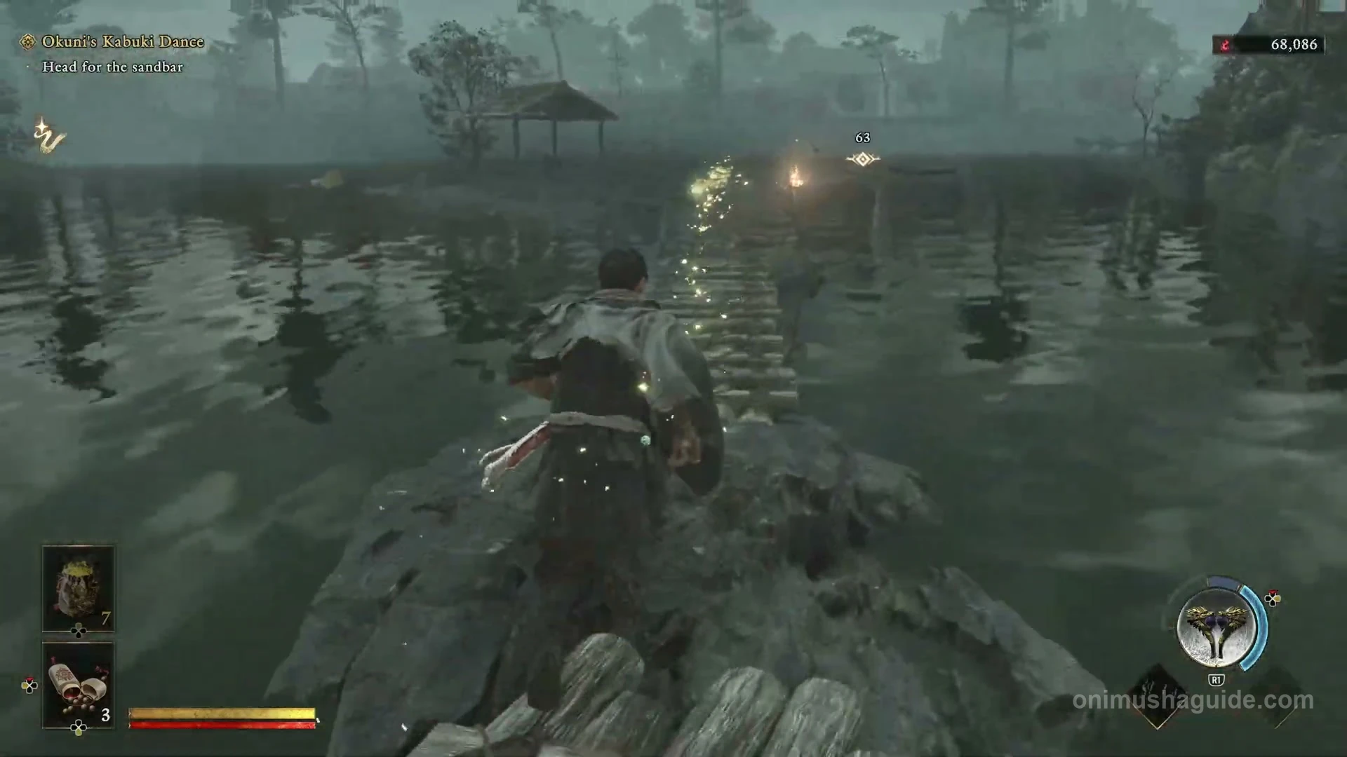 Low stone crossing through the river shallows leading to Okuni beside a torch