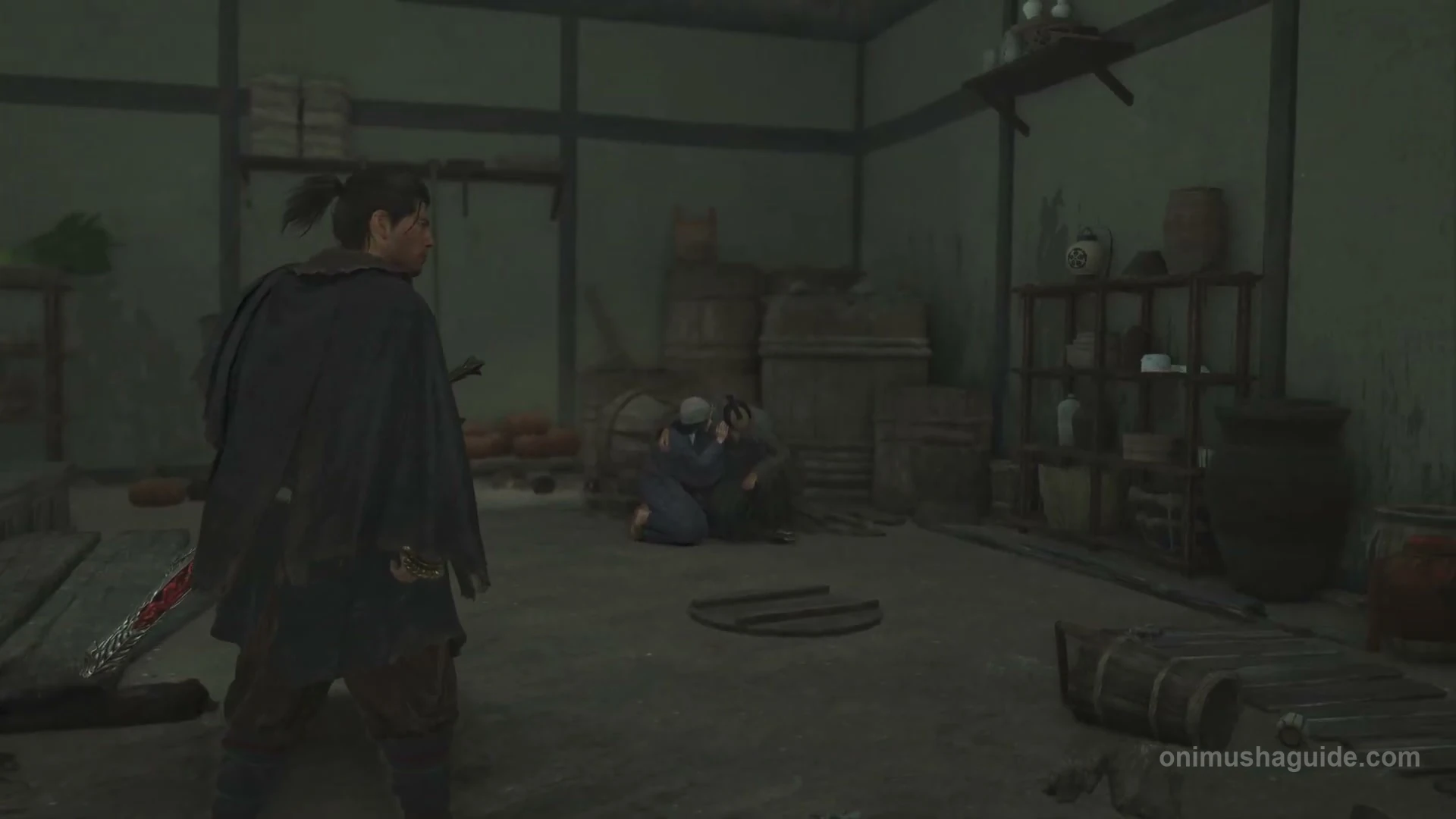 Injured man lying inside the thatched house with a woman beside him