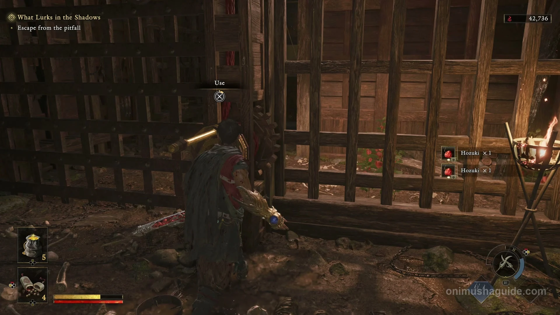 Crank beside the torch and barred gate leading out of the pitfall